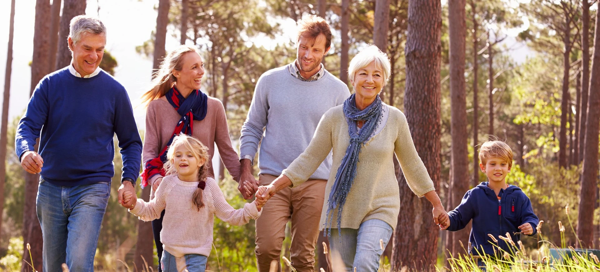 Multi-generational family walking together pain-free in nature